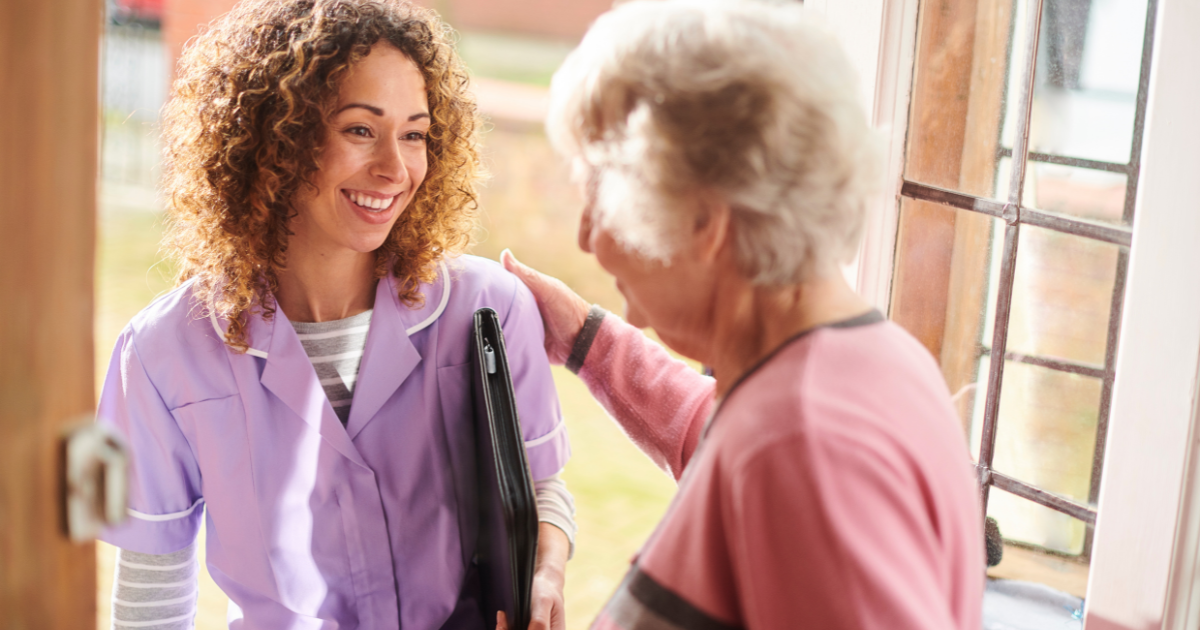 A caregiver enjoys her job as as she visits a senior client.