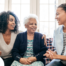A professional explains senior care options to a woman and her aging mom.