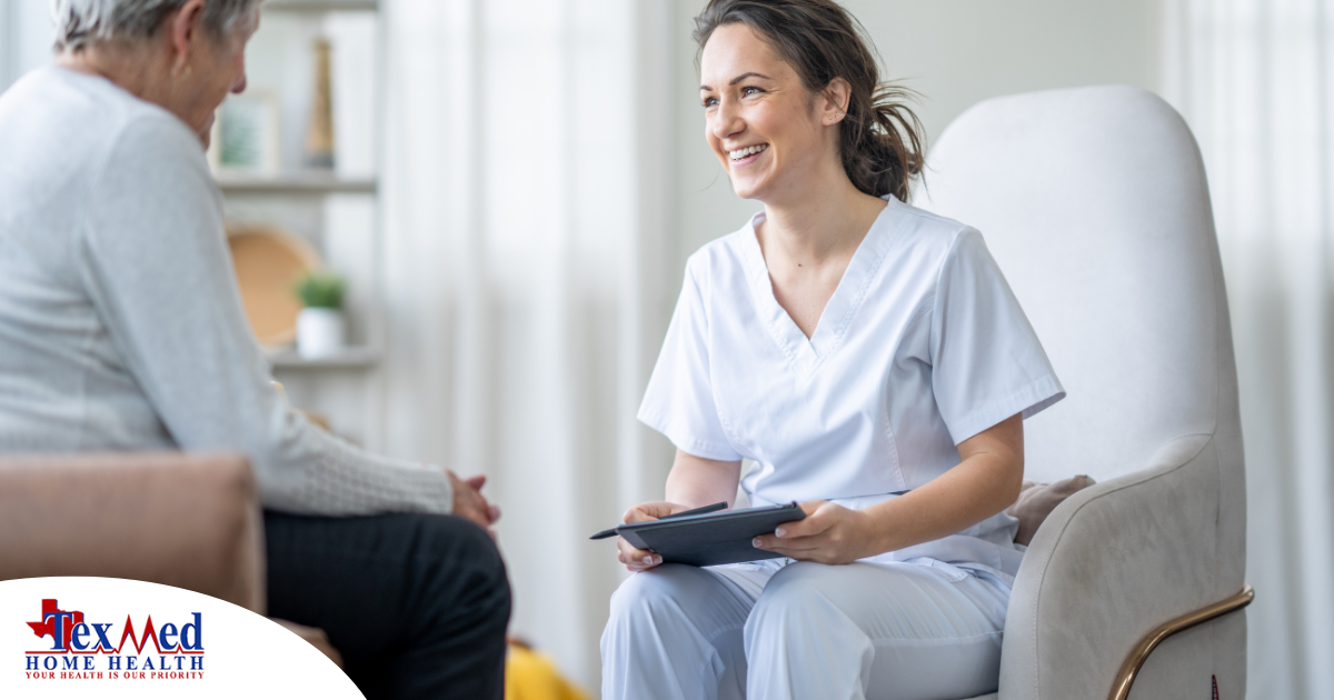 A woman smiles and enjoys her caregiving job as she writes notes down with a client.