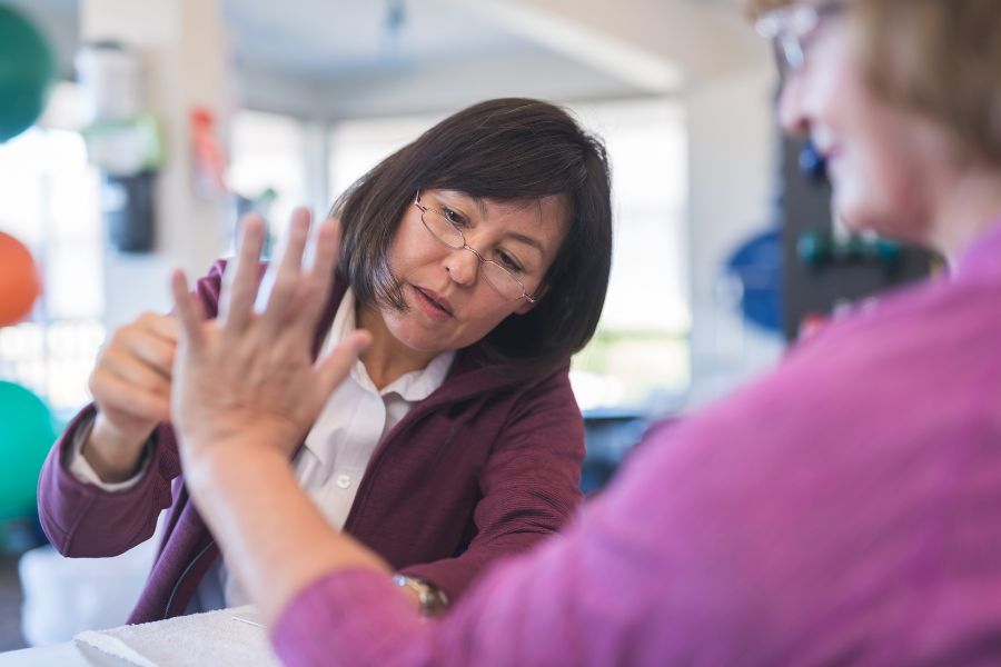 Occupation Therapy in Killeen TX A woman works with a patient's wrist flexibility, showing how occupational therapy services can help those in Killeen.