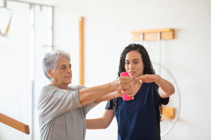 physical therapy in killeen, tx A physical therapist helps an older client with exercise, representing how physical therapy in Killeen can help.