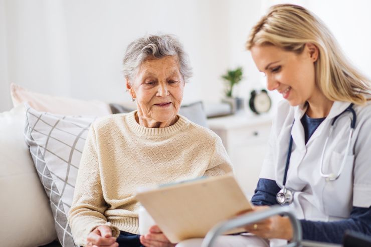 Speech Therapy in Copperas Cove A doctor sits next to an elderly woman going over medical records. Speech Therapy in Copperas Cove