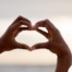 2 hands making a heart represent self-care, a vital concept to appreciate as a caregiver.