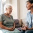 A caregiver sits and spends time with a client, representing how non-medical home care can benefit older loved ones.