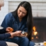 A nurse helps a patient at home with her medications, representing how home health nurses can help with disease management.