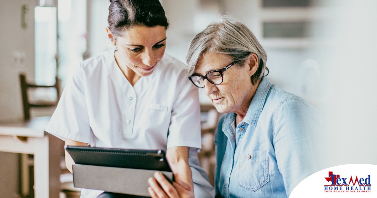 A nurse helps an older patient by showing her a tablet representing the role of tech in registered nurses’ roles in care.