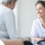 A woman smiles while with a client representing the pros of the home care industry.