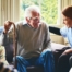 A woman has a good time with her older clients, representing the kind of personal skills needed to be a good caregiver.