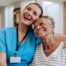 Young home health care nurse helping senior man to recover at home