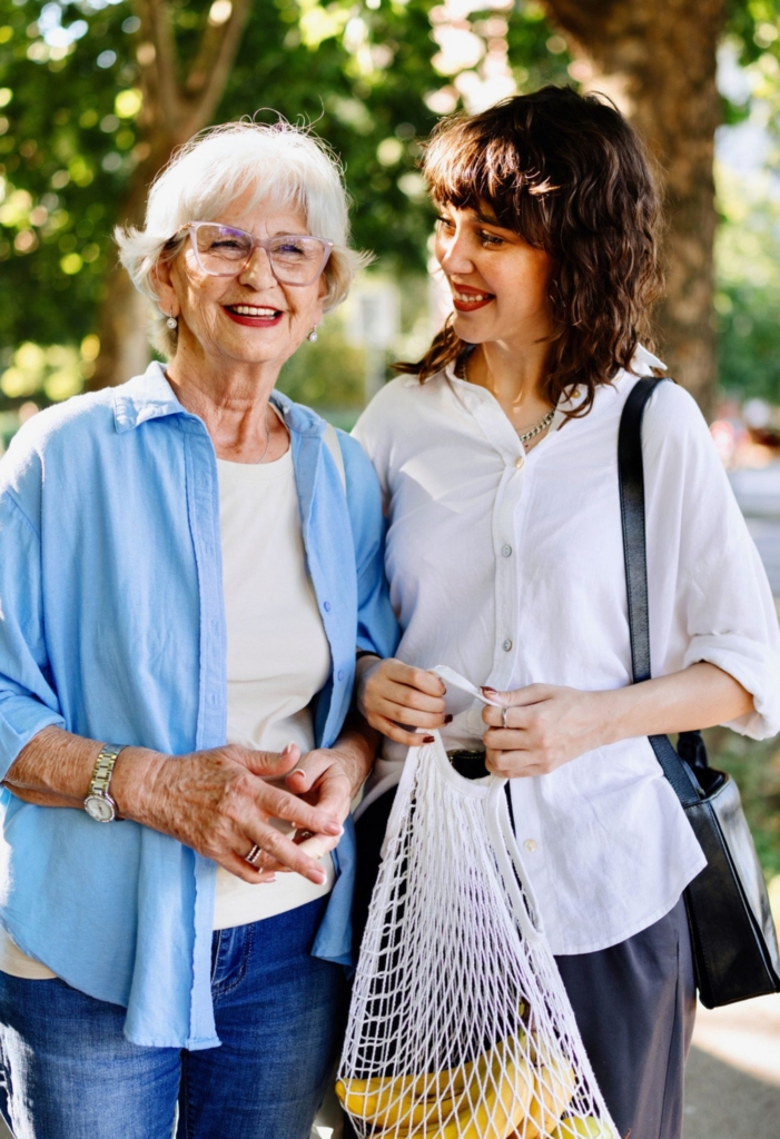 Caregiver walking with a senior woman outdoors, reflecting Companionship Care in Waco